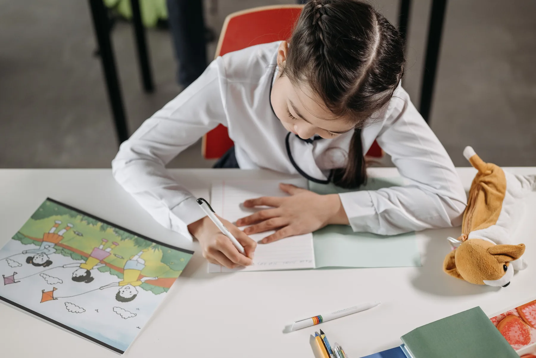 Student writing in a classroom